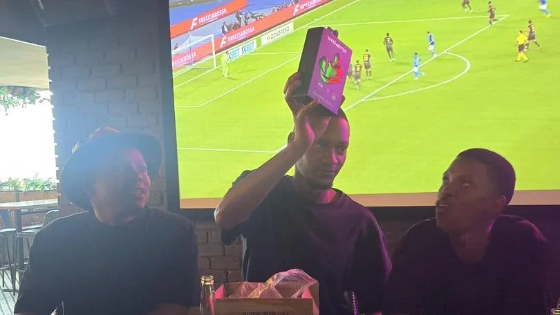 A team member showing his year-end gift
