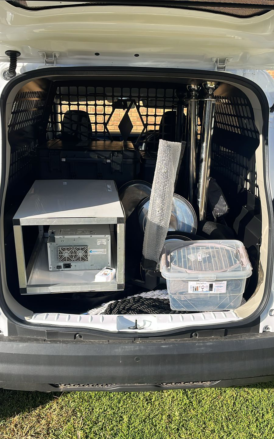 Rear of a vehicle loaded with equipment cases and stands
