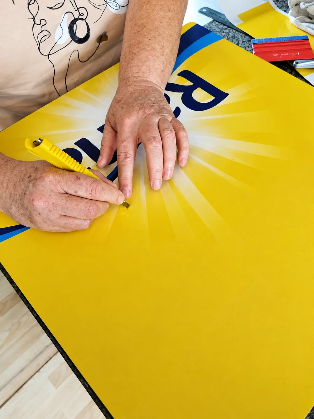 Trimming and finishing the Rama vinyl branding by hand