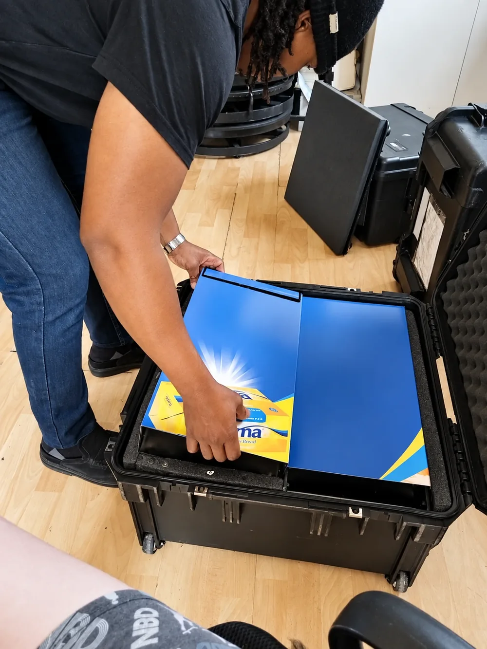 Packing Rama-branded booth panels into a protective crate
