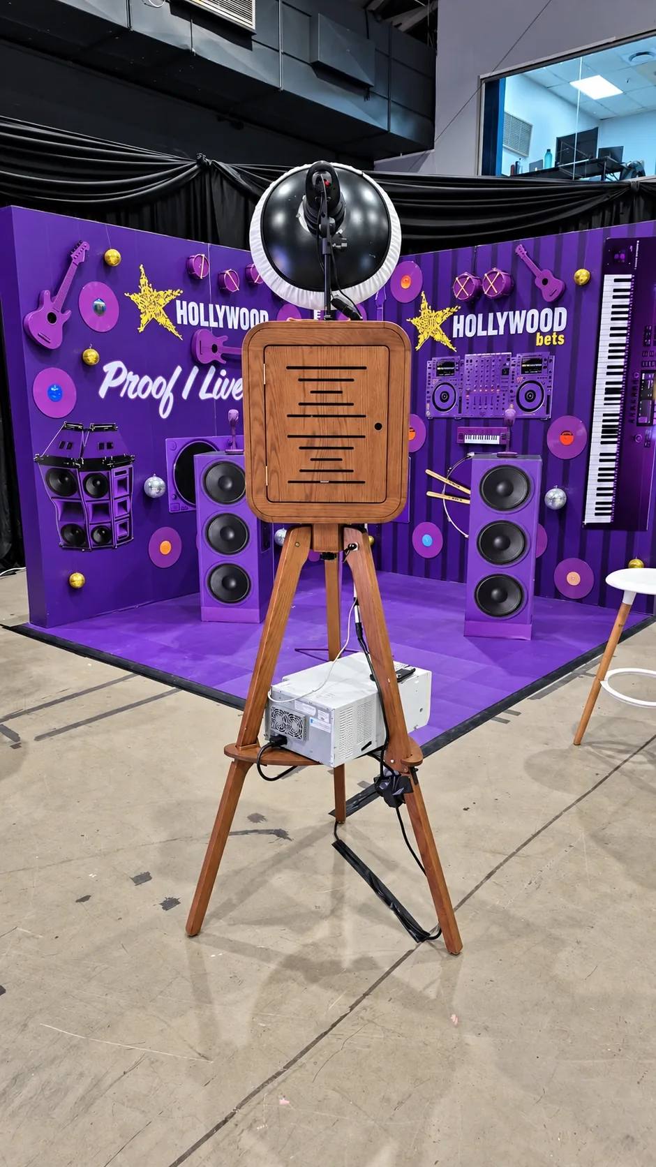 Retro-style booth and purple branded event backdrop