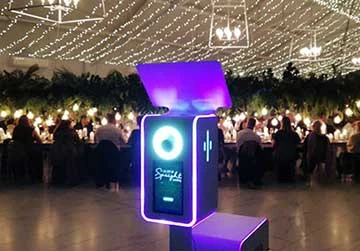 A Nano photo booth positioned among guests at a busy conference function