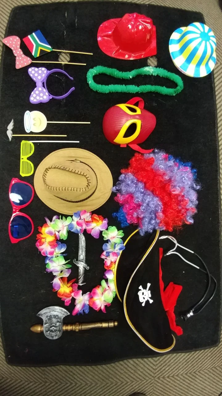A basic selection of traditional photo booth props including hats, glasses, wigs and signs