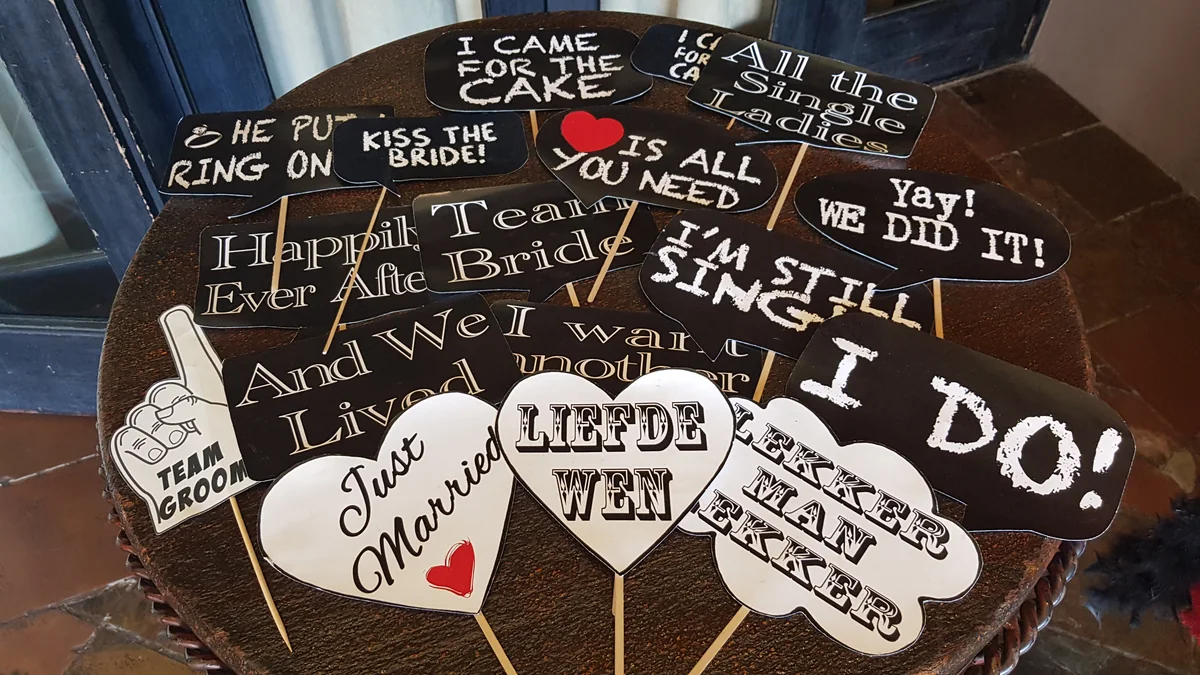 Wedding speech bubbles and signs arranged for guests at a photo booth