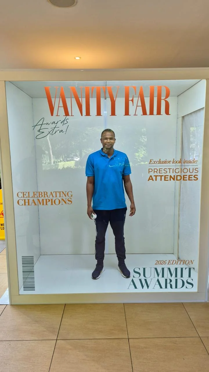 A man posing inside the awards magazine booth