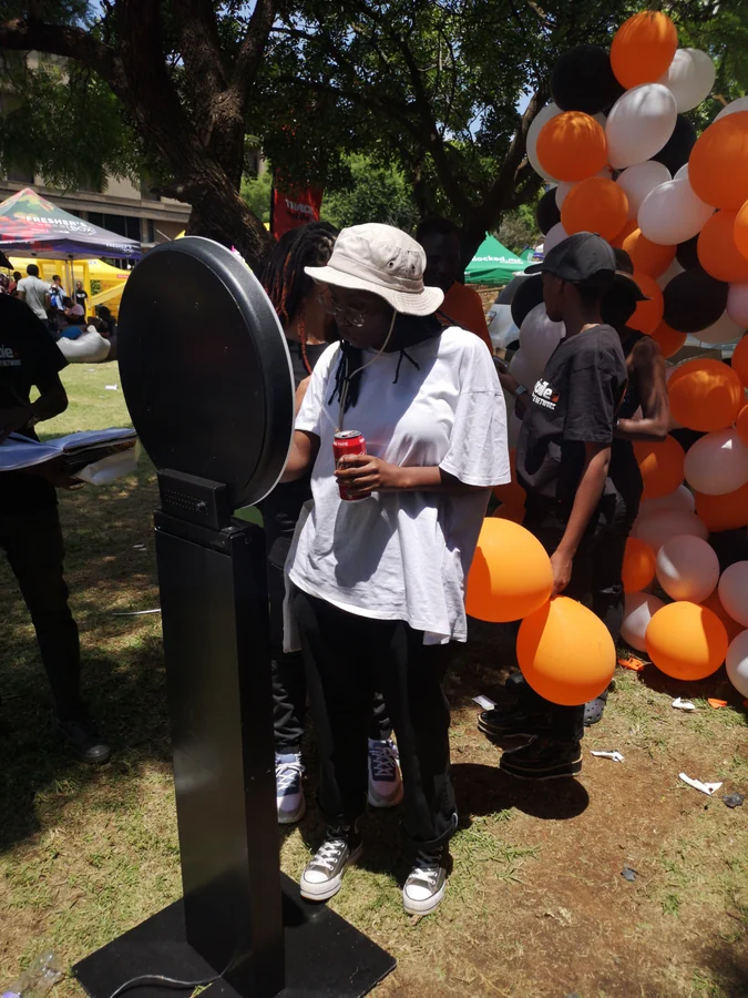 Guests using a photo booth during an outdoor event