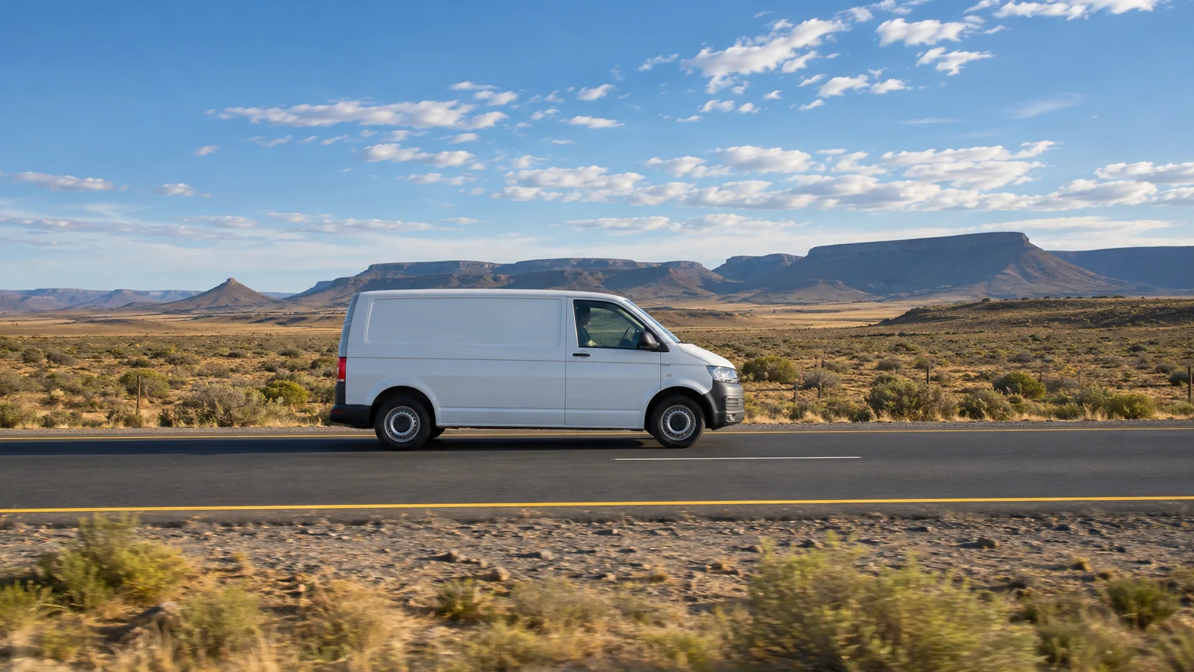 Illustrative image of a white panel van travelling through the Northern Cape Karoo on the N1