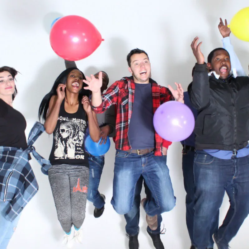 Guests jumping with colourful balloons