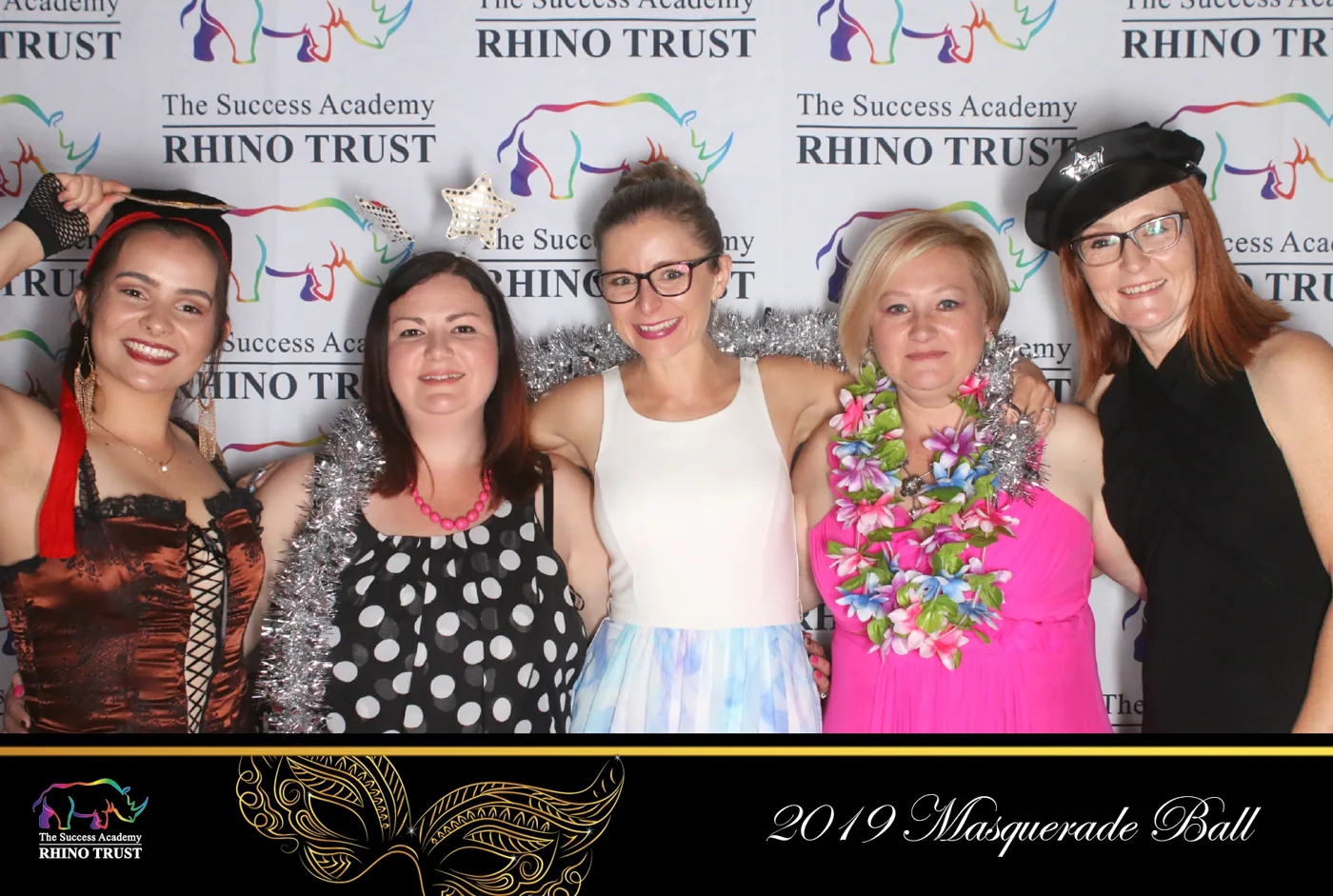Guests enjoying photo booth props at the Rhino Trust 2019 Masquerade Ball