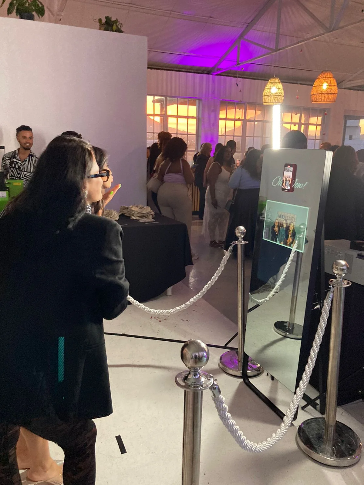 Guests enjoying the Mirror Booth at an evening event