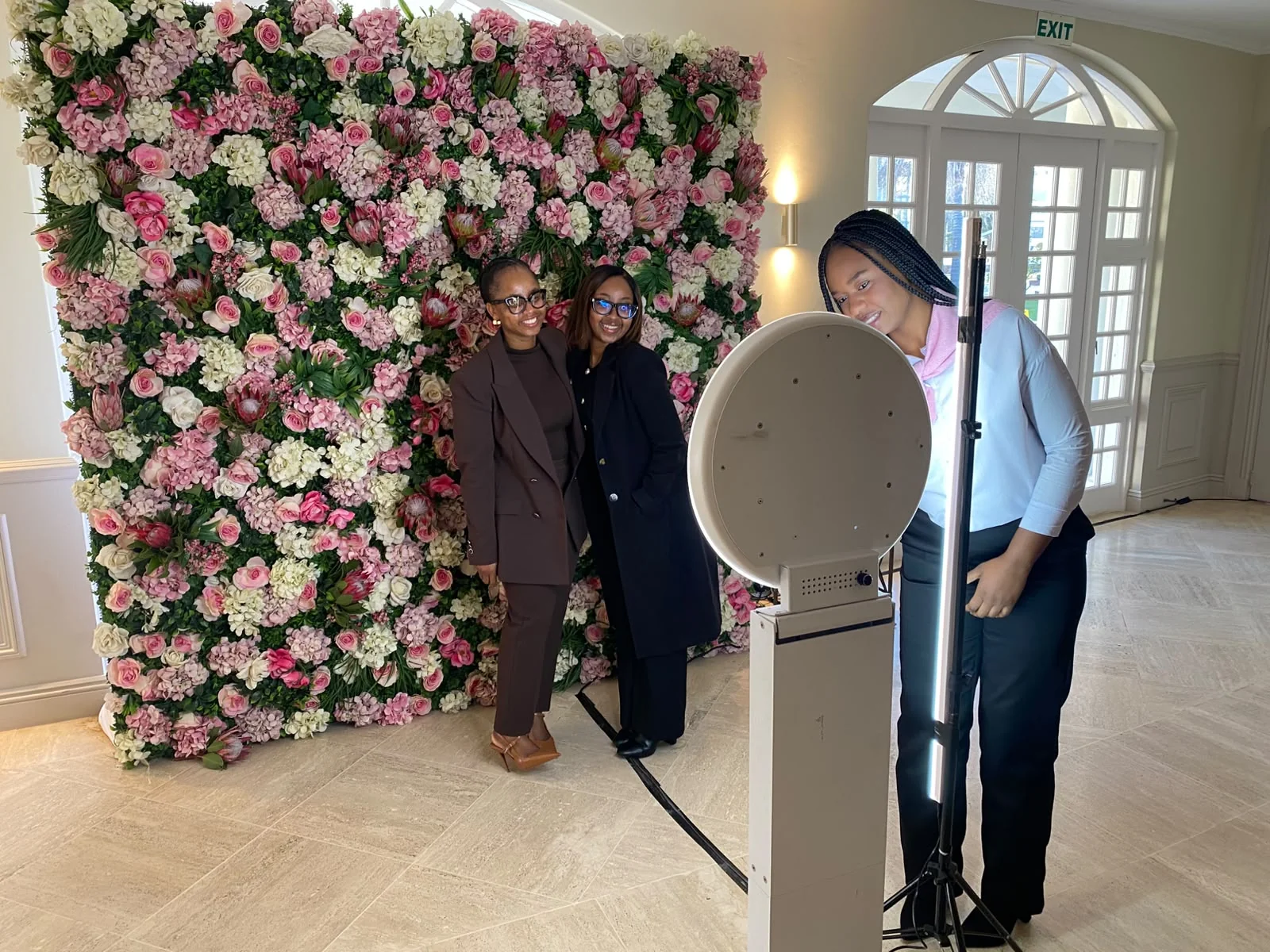 SelfieBox floral Spring Day photo booth setup with guests and a flower wall