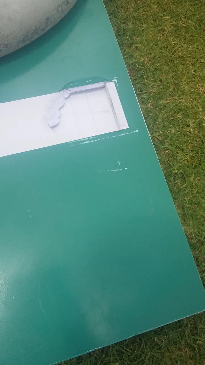 A broken panel on a photo booth casing