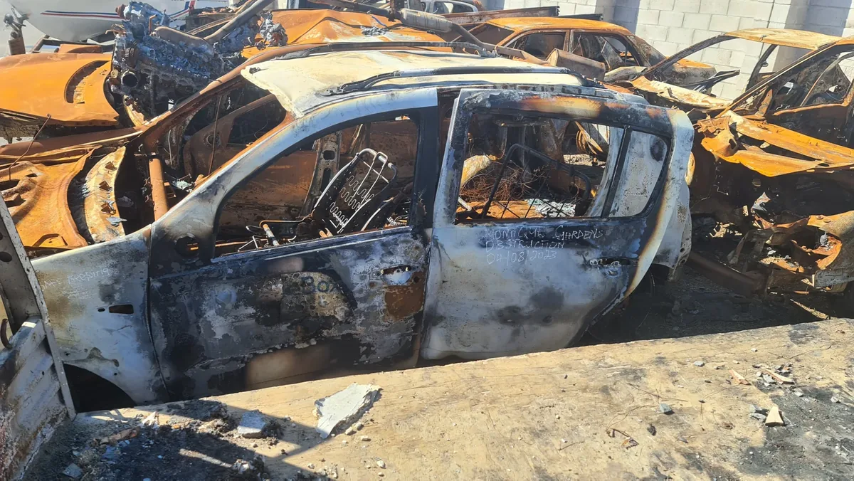 Burnt-out SelfieBox vehicle in a yard
