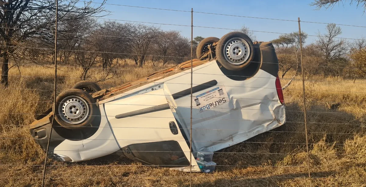 An overturned vehicle beside the road.