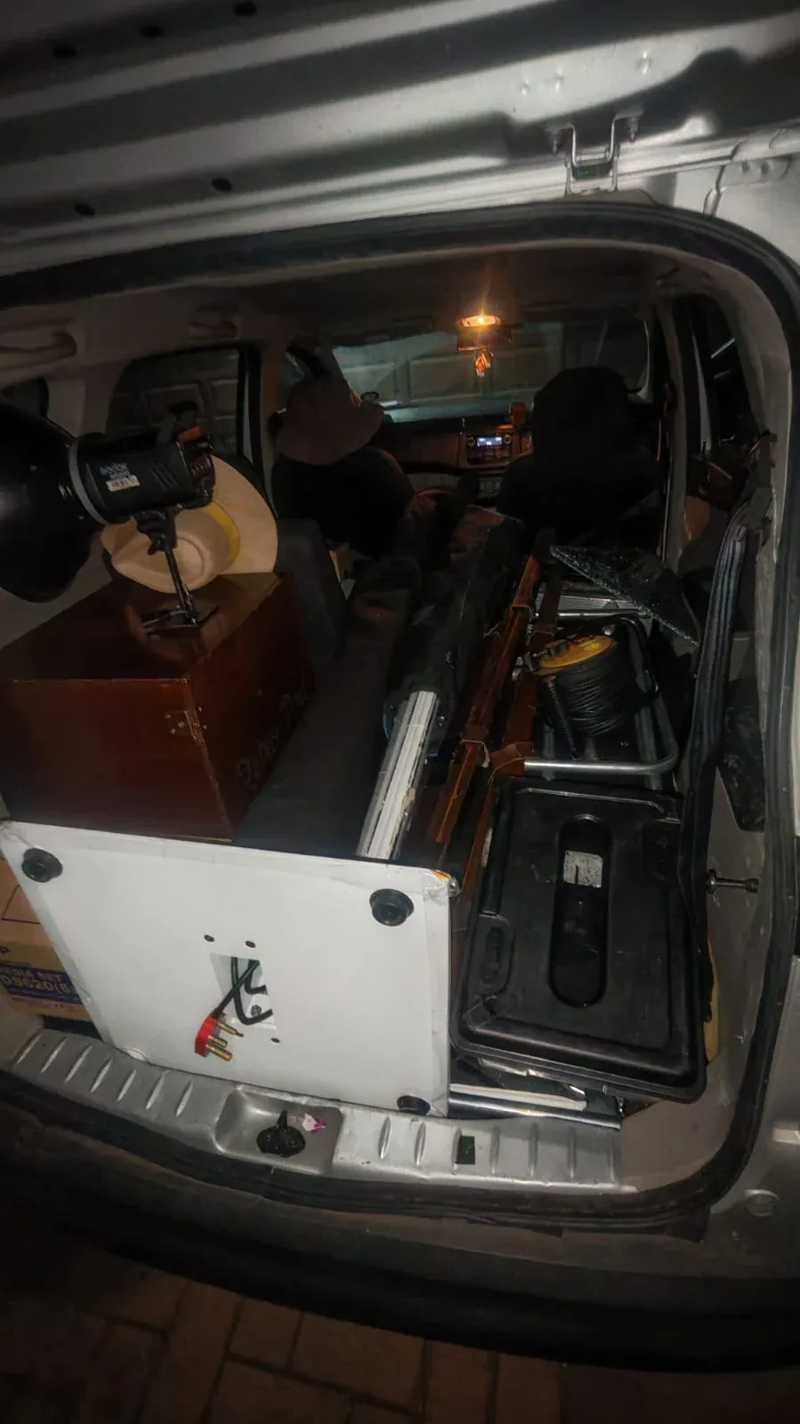 A vehicle carrying equipment, with a rear window broken.