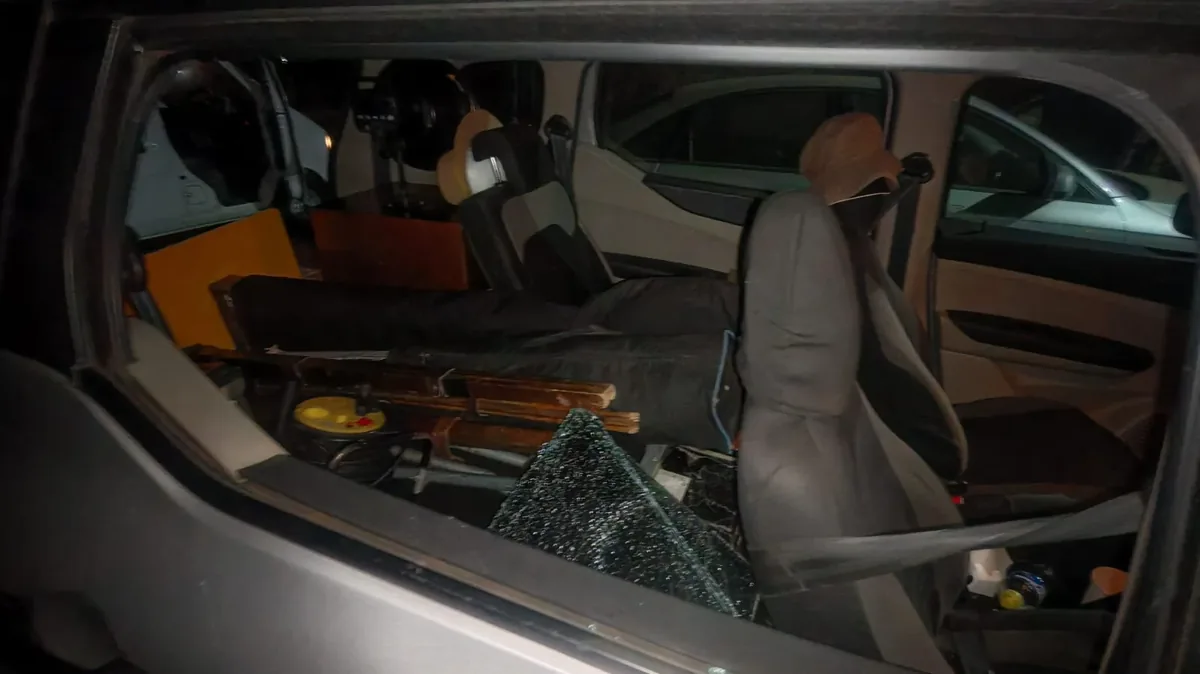 Broken glass inside a vehicle loaded with equipment.