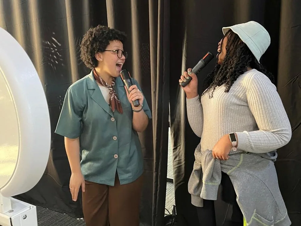 Two guests enjoying a KaraokeStar duet with SelfieBox